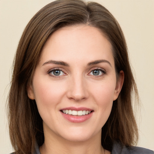 Joyful white young-adult female with long  brown hair and grey eyes