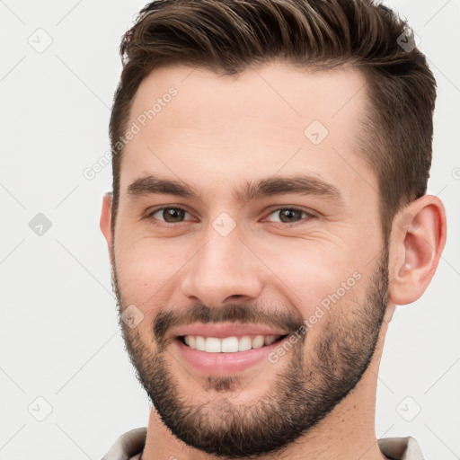 Joyful white young-adult male with short  brown hair and brown eyes