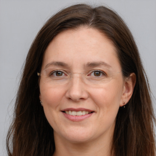 Joyful white adult female with long  brown hair and grey eyes