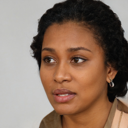 Neutral black young-adult female with short  black hair and brown eyes