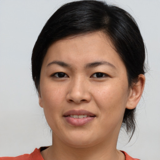Joyful asian young-adult female with medium  brown hair and brown eyes
