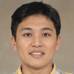 Joyful asian young-adult male with short  brown hair and brown eyes