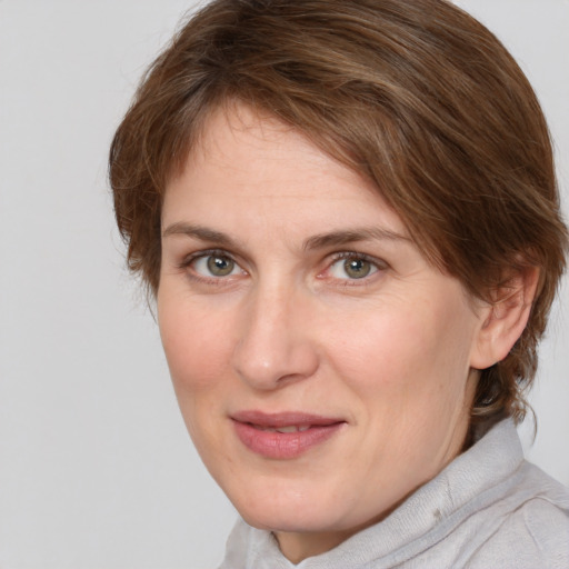 Joyful white adult female with medium  brown hair and grey eyes