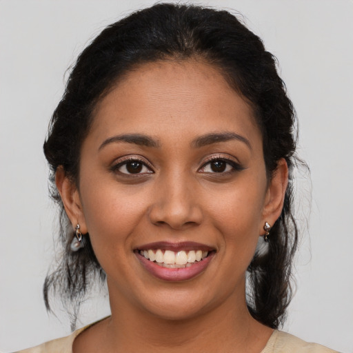 Joyful latino young-adult female with medium  brown hair and brown eyes
