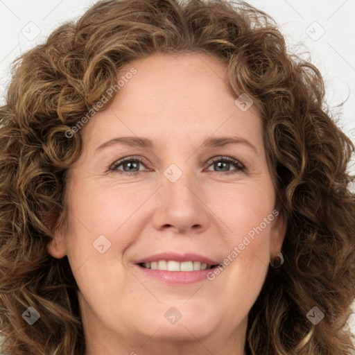 Joyful white young-adult female with long  brown hair and green eyes