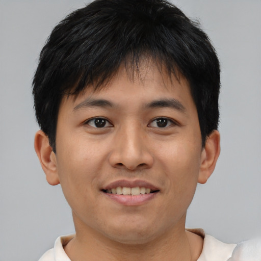 Joyful asian young-adult male with short  brown hair and brown eyes