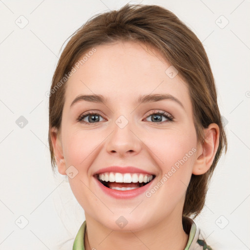 Joyful white young-adult female with medium  brown hair and green eyes