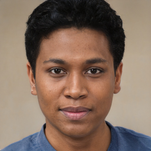 Joyful black young-adult male with short  black hair and brown eyes
