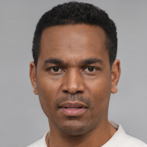 Neutral latino adult male with short  black hair and brown eyes