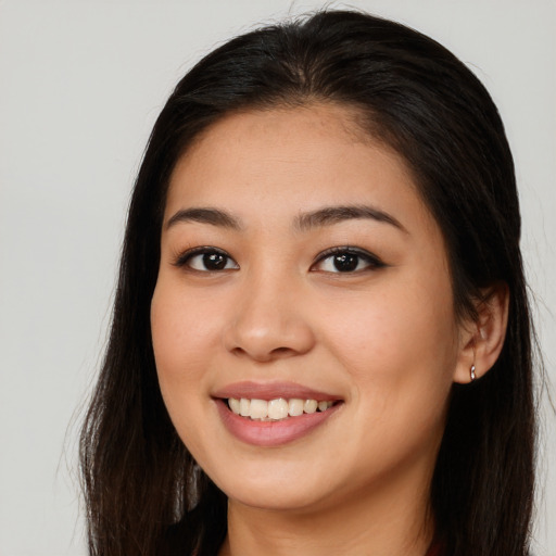 Joyful asian young-adult female with long  brown hair and brown eyes