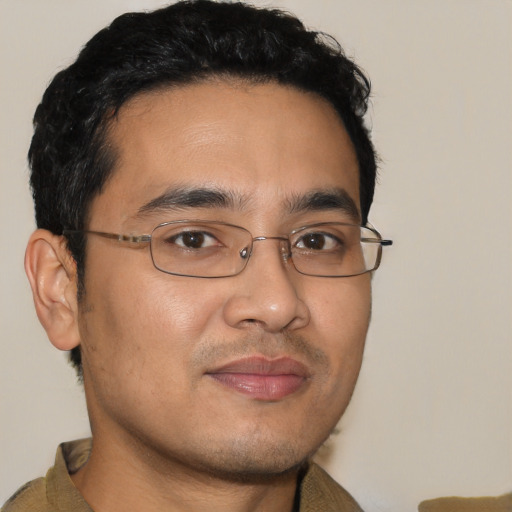 Joyful latino young-adult male with short  brown hair and brown eyes