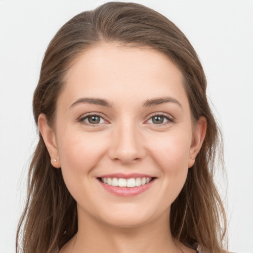 Joyful white young-adult female with long  brown hair and grey eyes