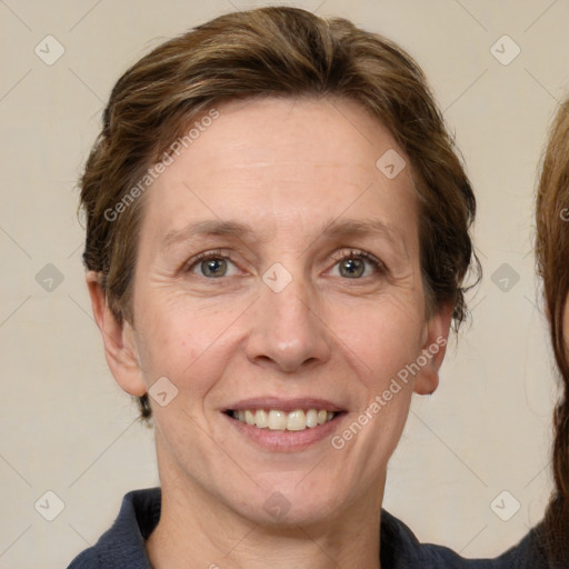 Joyful white adult female with medium  brown hair and grey eyes