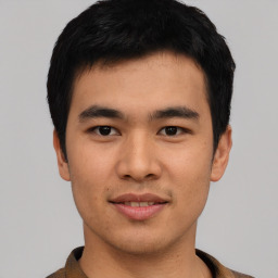 Joyful asian young-adult male with short  black hair and brown eyes