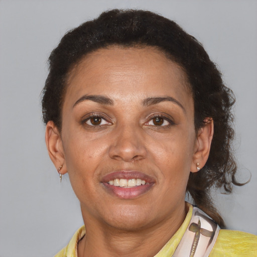Joyful latino adult female with short  brown hair and brown eyes