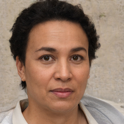 Joyful white adult female with short  brown hair and brown eyes