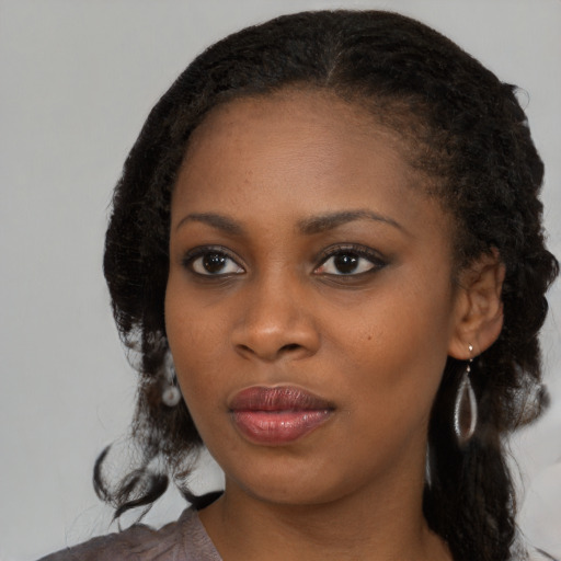 Neutral black young-adult female with medium  black hair and brown eyes