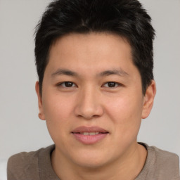 Joyful asian young-adult male with short  brown hair and brown eyes