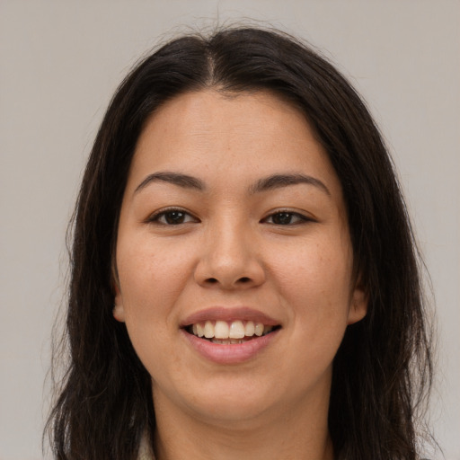 Joyful white young-adult female with long  brown hair and brown eyes