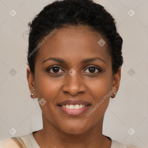 Joyful black young-adult female with short  brown hair and brown eyes