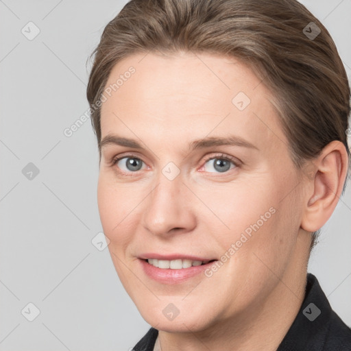 Joyful white adult female with medium  brown hair and grey eyes