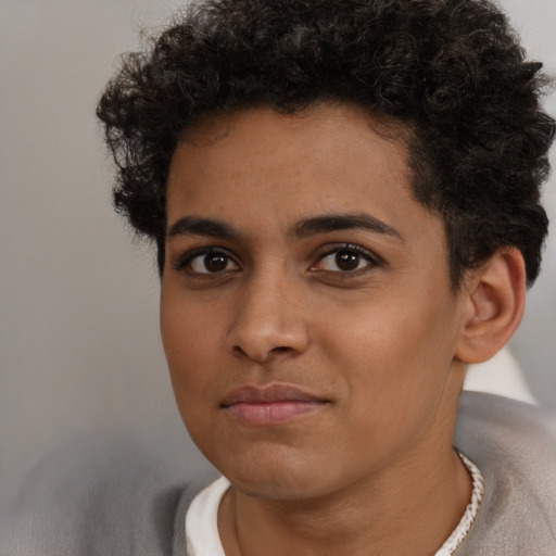Joyful latino young-adult male with short  brown hair and brown eyes