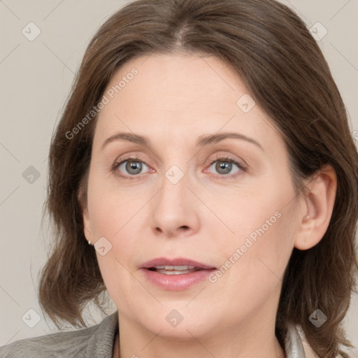 Joyful white adult female with medium  brown hair and grey eyes