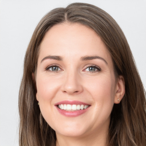 Joyful white young-adult female with long  brown hair and grey eyes