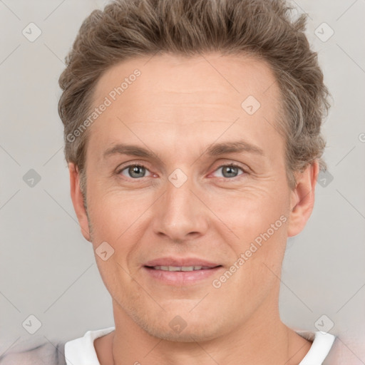 Joyful white adult male with short  brown hair and grey eyes