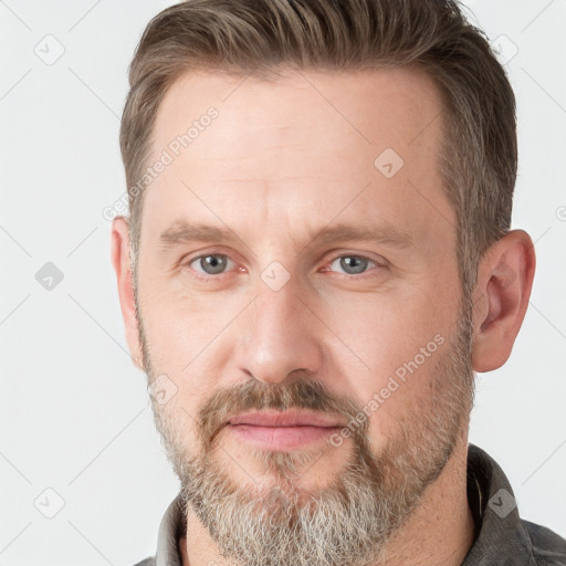 Joyful white adult male with short  brown hair and grey eyes