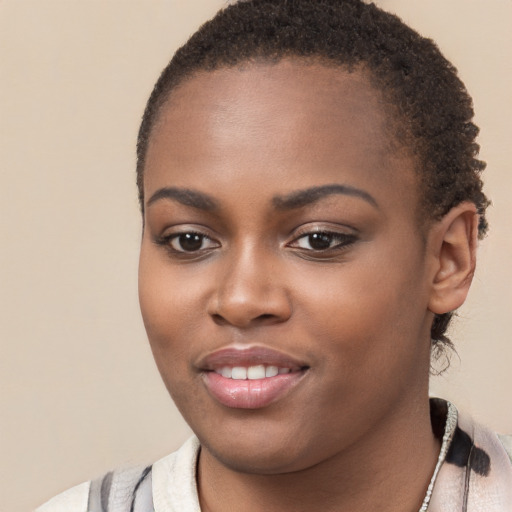 Joyful black young-adult female with short  brown hair and brown eyes