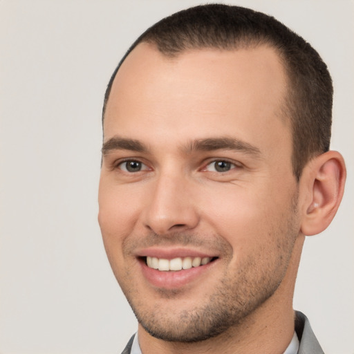 Joyful white young-adult male with short  brown hair and brown eyes