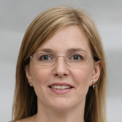 Joyful white young-adult female with long  brown hair and blue eyes