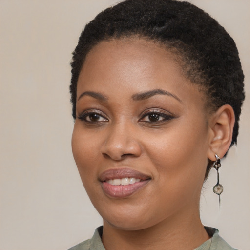 Joyful black young-adult female with medium  black hair and brown eyes