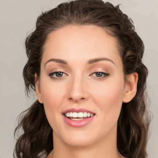 Joyful white young-adult female with medium  brown hair and green eyes