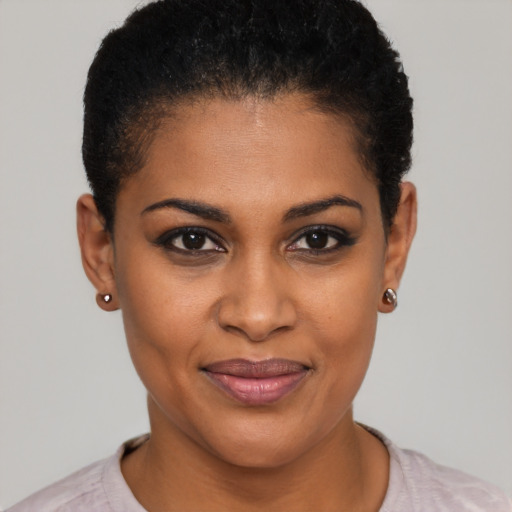 Joyful black young-adult female with short  black hair and brown eyes