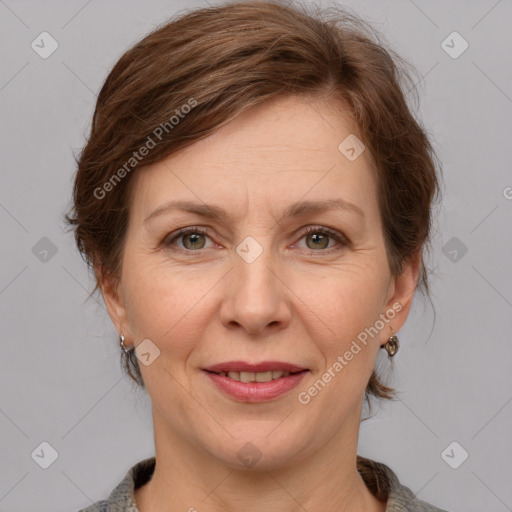 Joyful white adult female with medium  brown hair and grey eyes