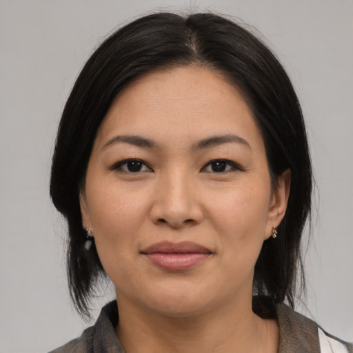 Joyful asian young-adult female with medium  black hair and brown eyes