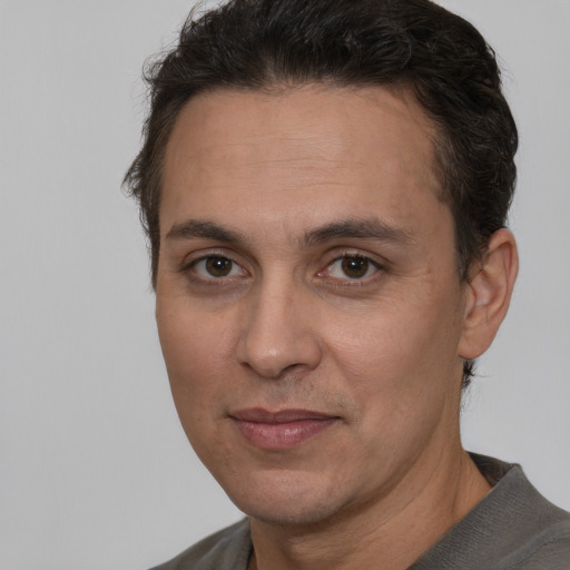 Joyful white adult male with short  brown hair and brown eyes