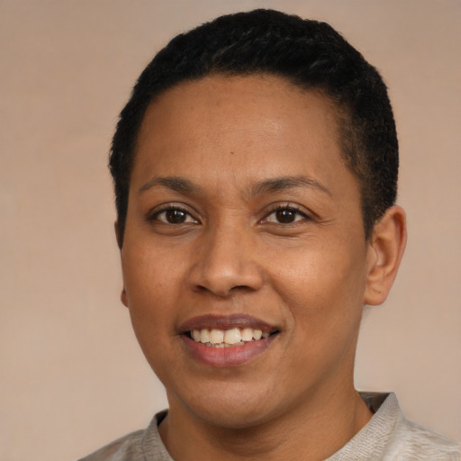 Joyful latino young-adult female with short  black hair and brown eyes