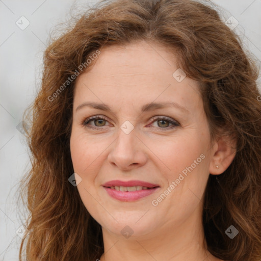 Joyful white adult female with long  brown hair and brown eyes