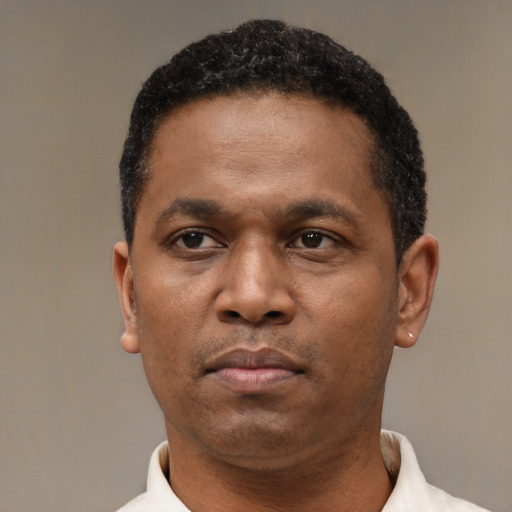 Neutral latino adult male with short  black hair and brown eyes