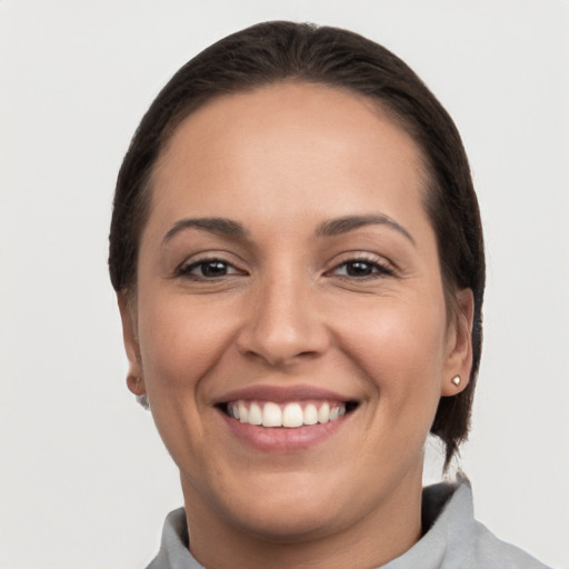 Joyful white young-adult female with short  brown hair and brown eyes