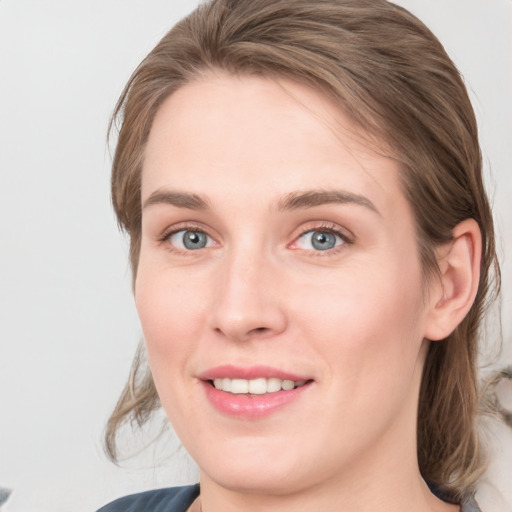 Joyful white young-adult female with medium  brown hair and blue eyes