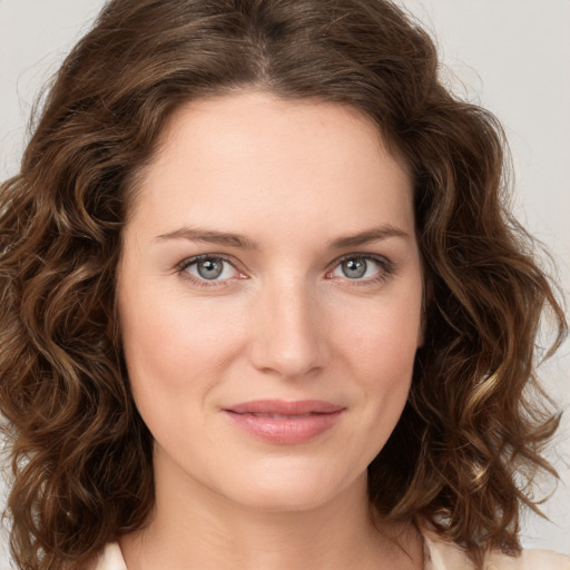 Joyful white young-adult female with medium  brown hair and green eyes