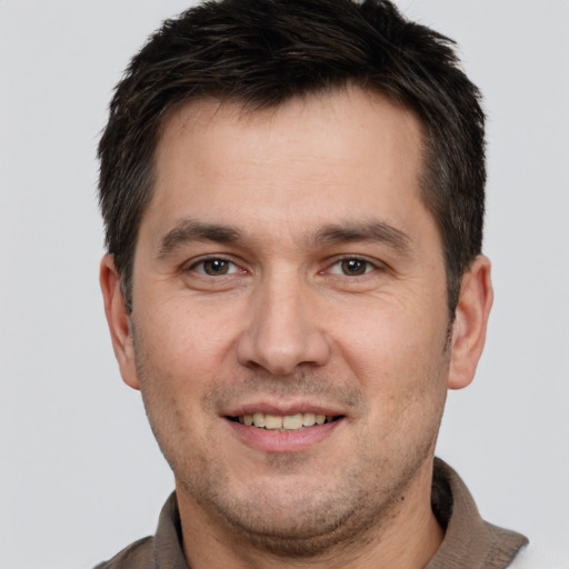 Joyful white adult male with short  brown hair and brown eyes