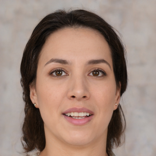 Joyful white young-adult female with medium  brown hair and brown eyes