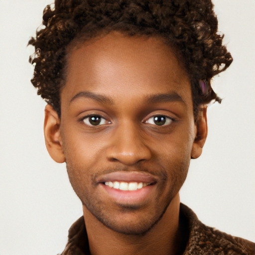 Joyful black young-adult male with short  brown hair and brown eyes