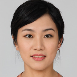 Joyful asian young-adult female with medium  black hair and brown eyes