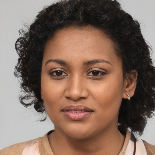 Joyful black young-adult female with medium  brown hair and brown eyes